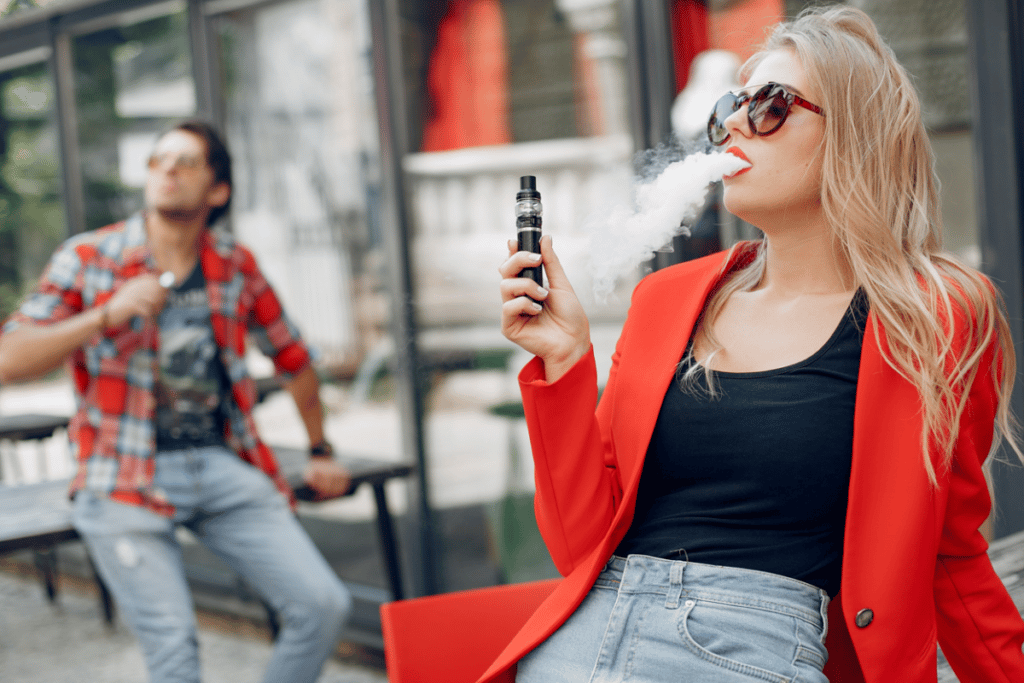 A guy and a girl vaping