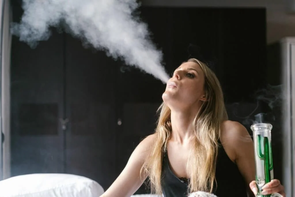 Woman smoking through bong