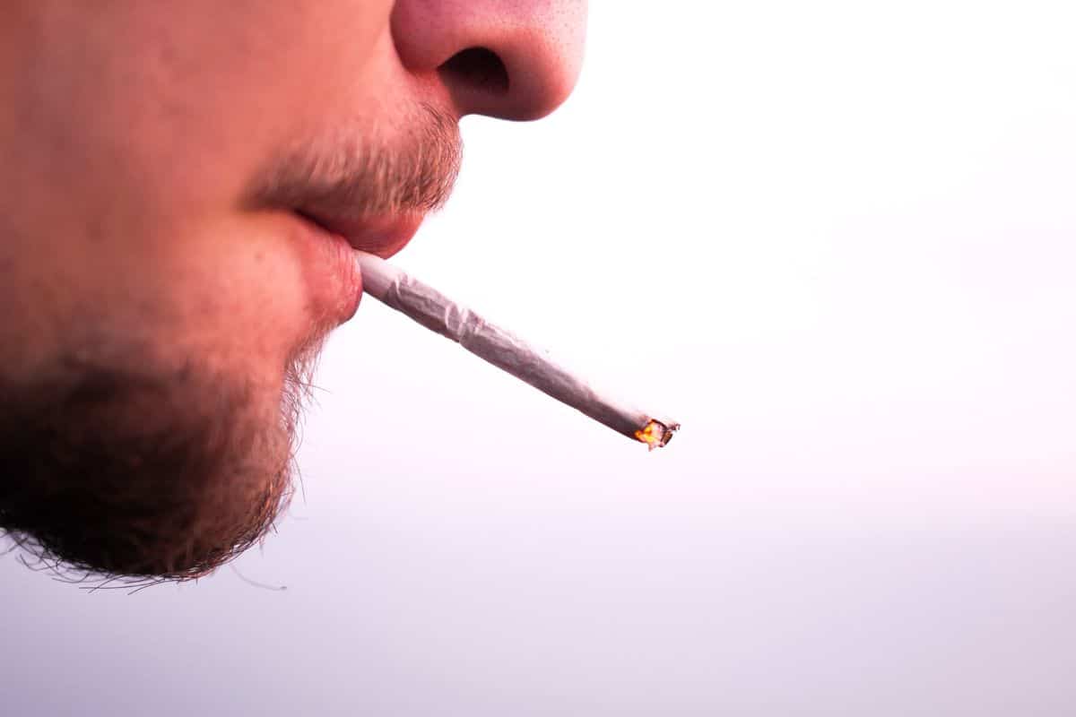 A man smoking a pre roll