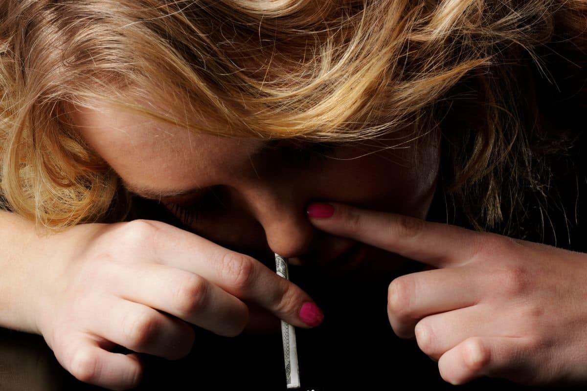 A woman snorting weed