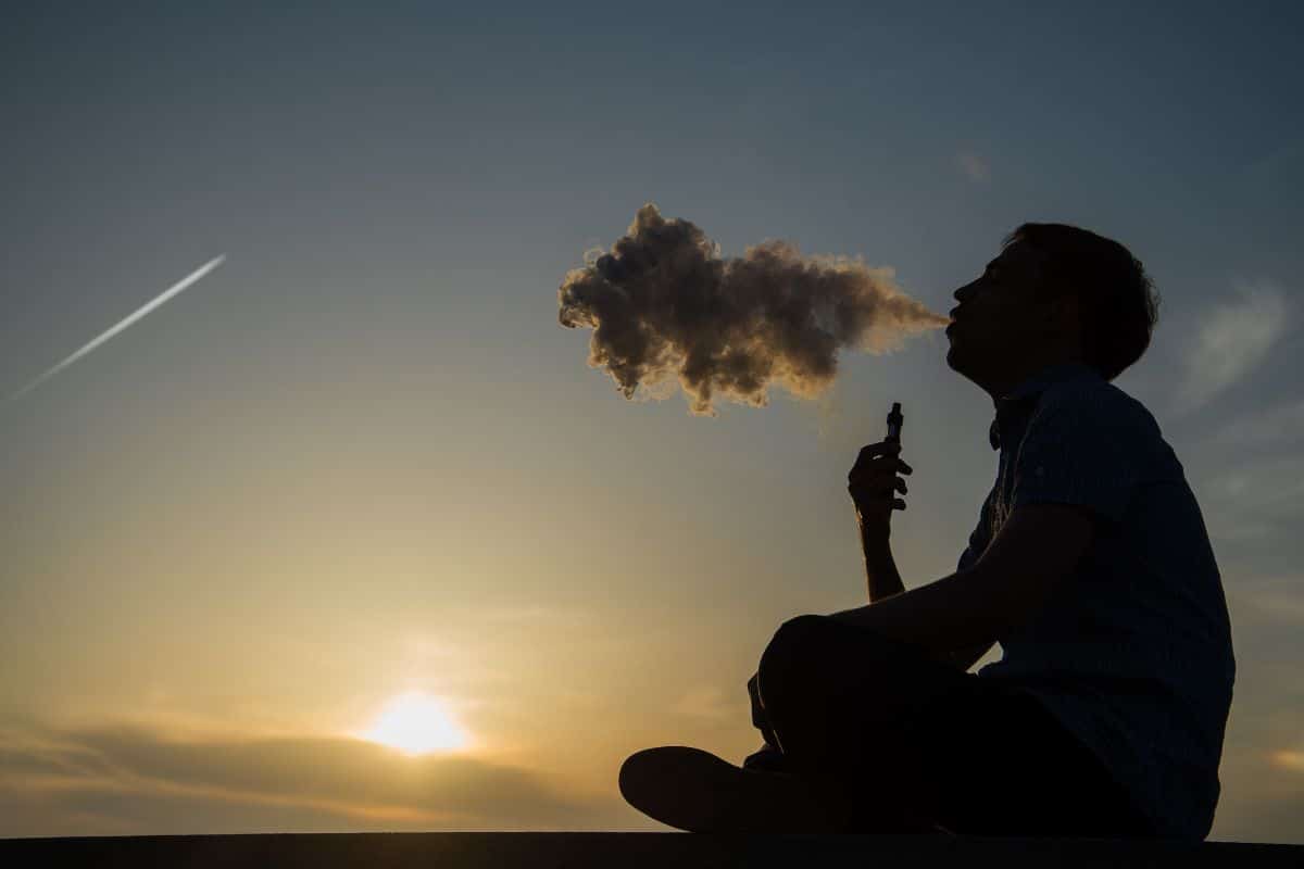 A man enjoying vaping outdoors