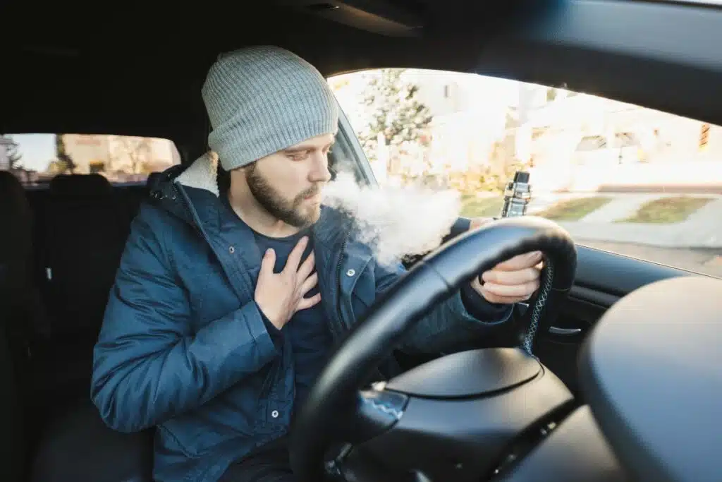 A guy coughing while vaping