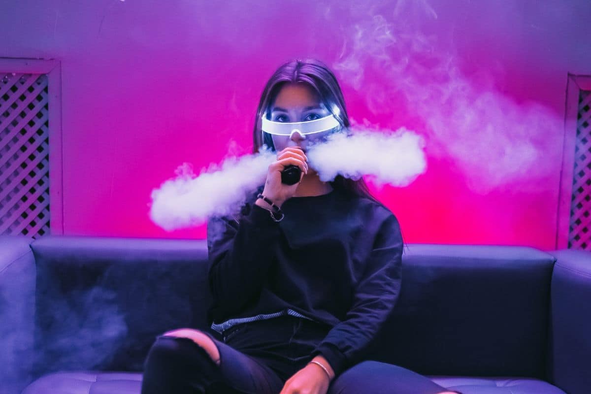 A lady vaping in a pub