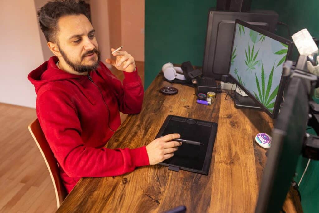 A man smoking weed while playing games on twitch