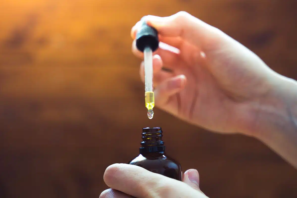 A lady holding CBD tincture in her hand