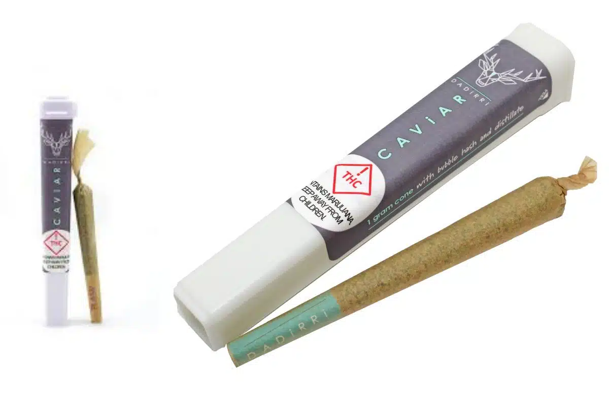 A tube of cannabis next to a rolled cigarette, showcasing the popular Caviar Pre-Rolls.
