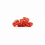 A pile of red gummy cubes on a white background.