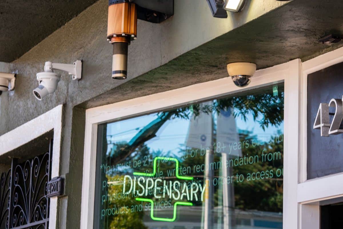 A storefront with a sign for a dispensary selling THCA products in Arkansas.