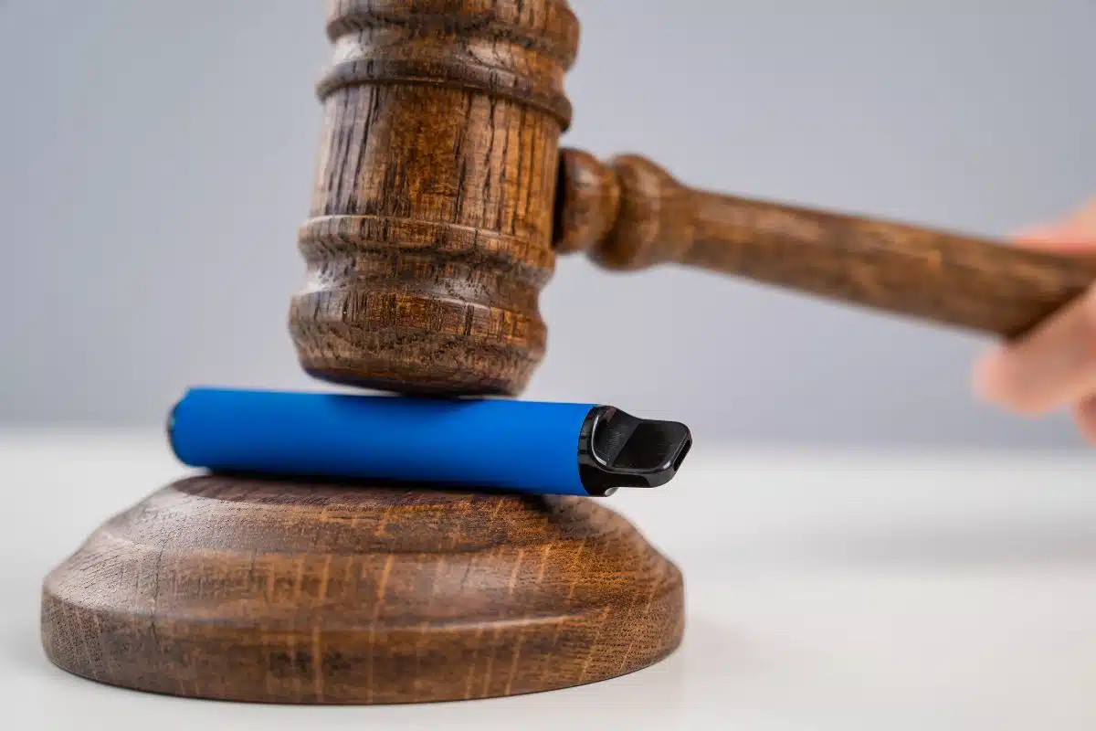 A gavel with a blue cigarette on top of it, emphasizing the "blue cigarette".