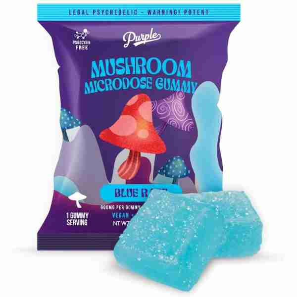 A package of "Purple Magic Enhanced Microdose Gummy" with one Blue Razz-flavored gummy outside the bag.