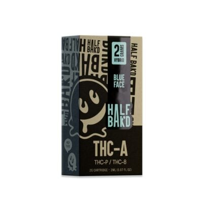 A cartridge box labeled "Half Bak'd Blue Face" with THCa, THC-P, and THC-8 information, featuring a cartoon face design on a dark background.