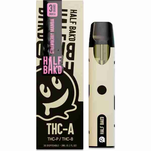 Half Bak'd branded THCA disposable vape pen in black and white, packaged in a pink and black box with a cartoon face design.