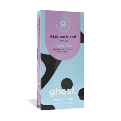 A light blue and purple box labeled "Ghost Essence Blend 2000 MG" contains a vape cartridge named "Candy Rain," featuring elements like Live Badder, THCa, HHC, and THC-P. As an Indica strain with a net weight of 2g (0.07 oz), the Ghost Essence Blend Cartridges promise a unique experience.