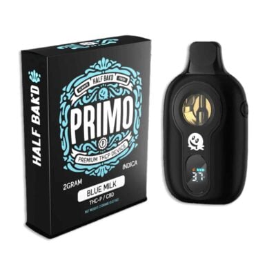 Image of a Half Bak'd Primo THCP Disposable box and the sleek black vaporizer device beside it. The packaging indicates it is a 2-gram Blue Milk Indica with THC/CBD.