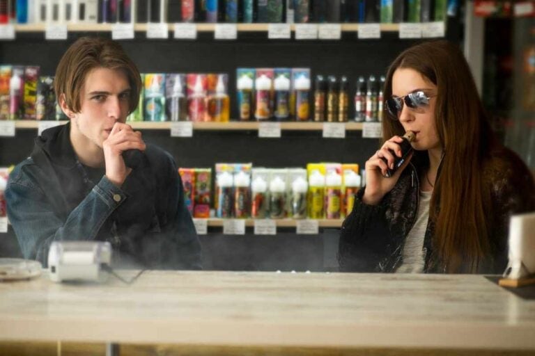 A couple vaping in a vape shop near a local gas station