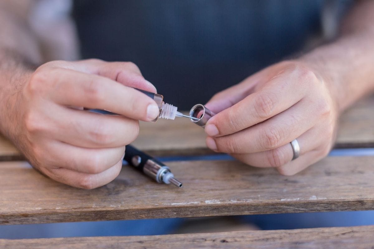 A person cleaning his dab pen for smoother hits