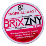 The round BRIXZNY Nicotine Pouches labeled Tropical Blast contain 8mg nicotine per pouch, with 15 pouches in total. A bottom warning reads, This product contains nicotine. Nicotine is an addictive chemical.