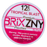 A round container labeled 12 MG Tropical Blast Premium BRIXZNY Nicotine Pouches 15 Pack stands against a white and pink backdrop. The warning highlights, This product contains nicotine. Nicotine is an addictive chemical.