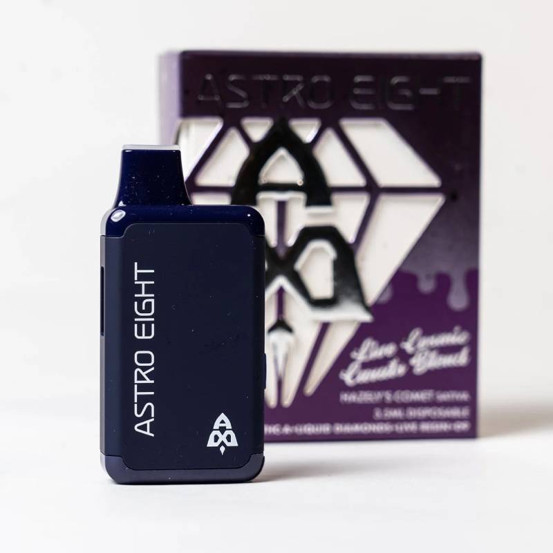 A dark purple and black vape device with ASTRO EIGHT written on it, placed in front of a purple box. The box has white and black graphics, featuring the text KRAKENS COMET, Live Resin Blend.