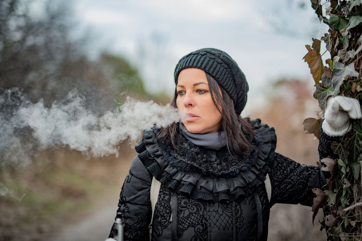 A lady vaping a vape device with thc in it