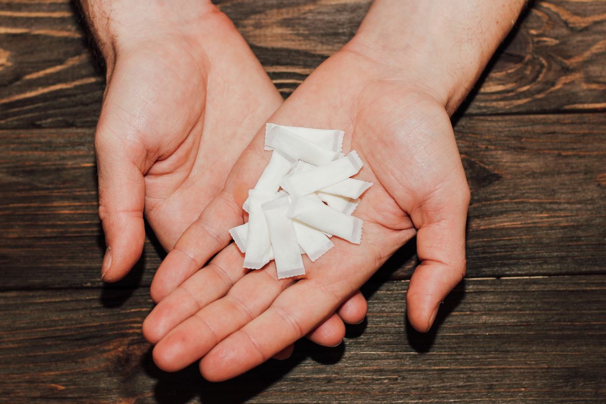 A person holding zyn nicotine pouches in his hands