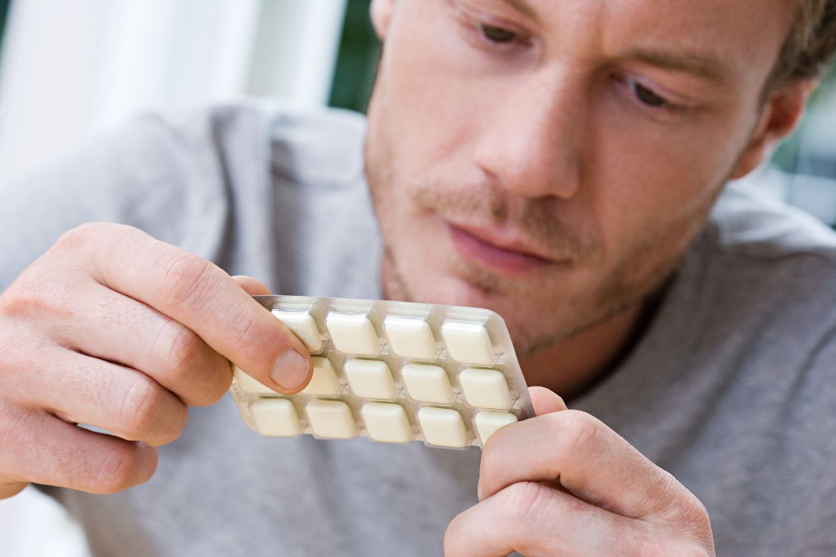 A person reading the information printed on nicotine gum pack