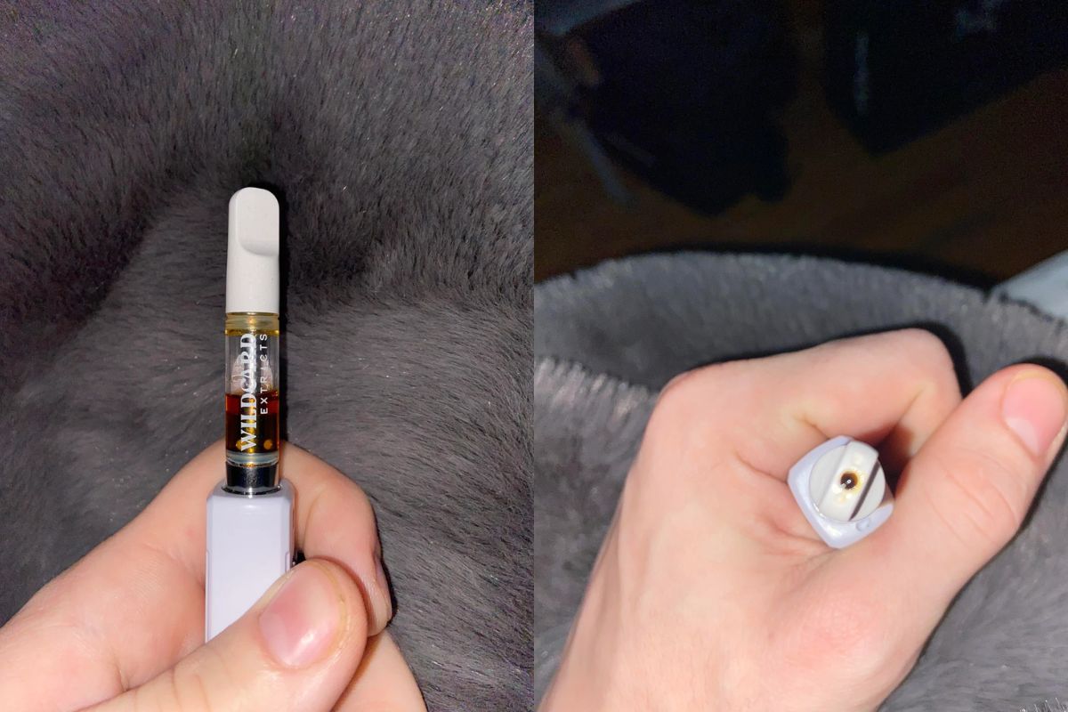 A person showing his clogged vape cart