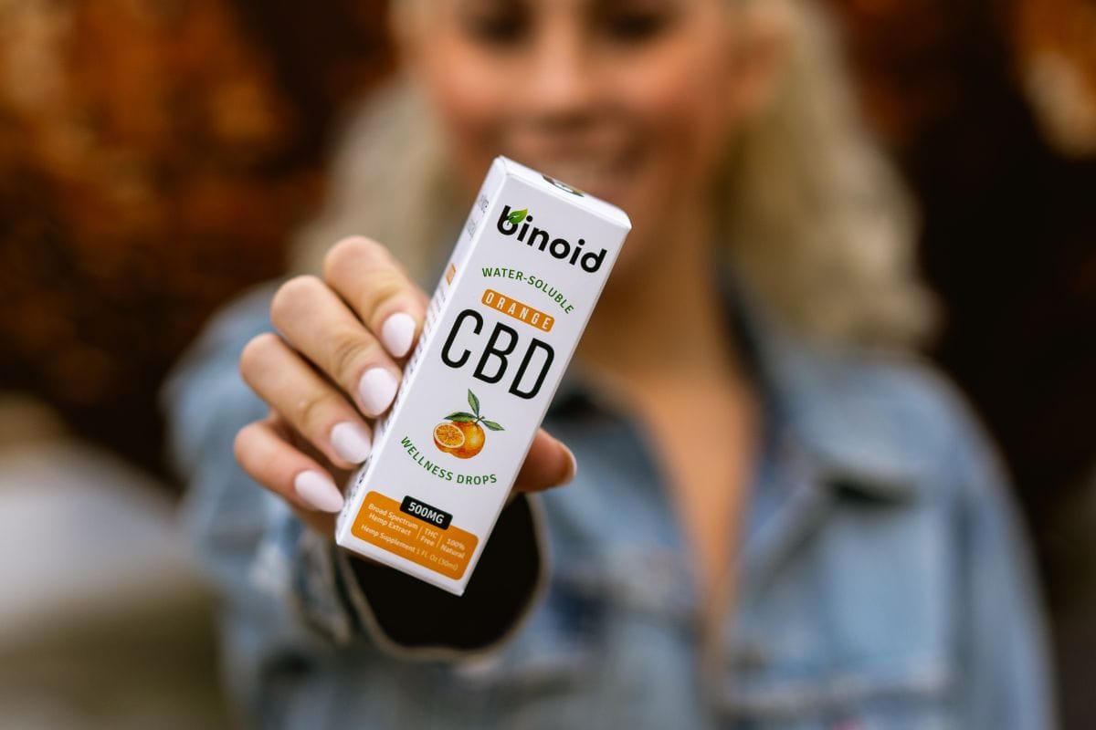 A lady holding cbd products