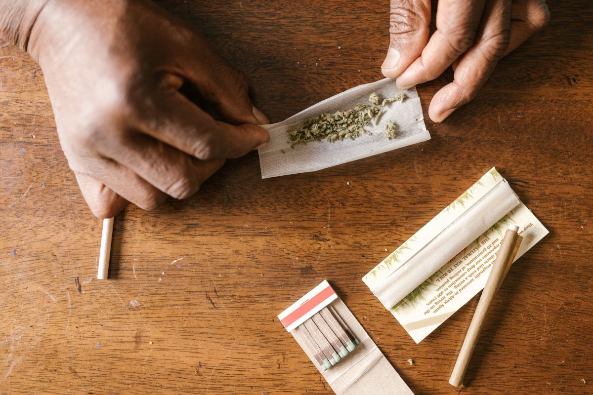 A person rolling a weed joint without filter