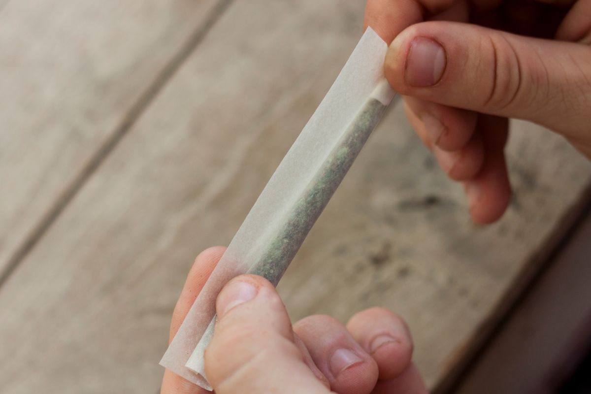 A person skillfully rolling a joint with bare hands
