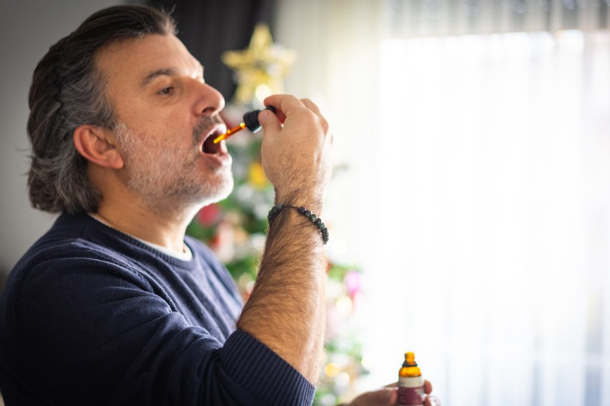 A person taking cbd oil for pain management