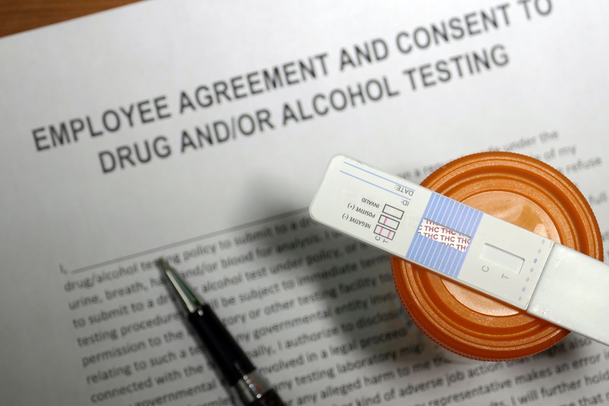 An image showing a commercial driver's regular drug testing agreement alongside the testing apparatus